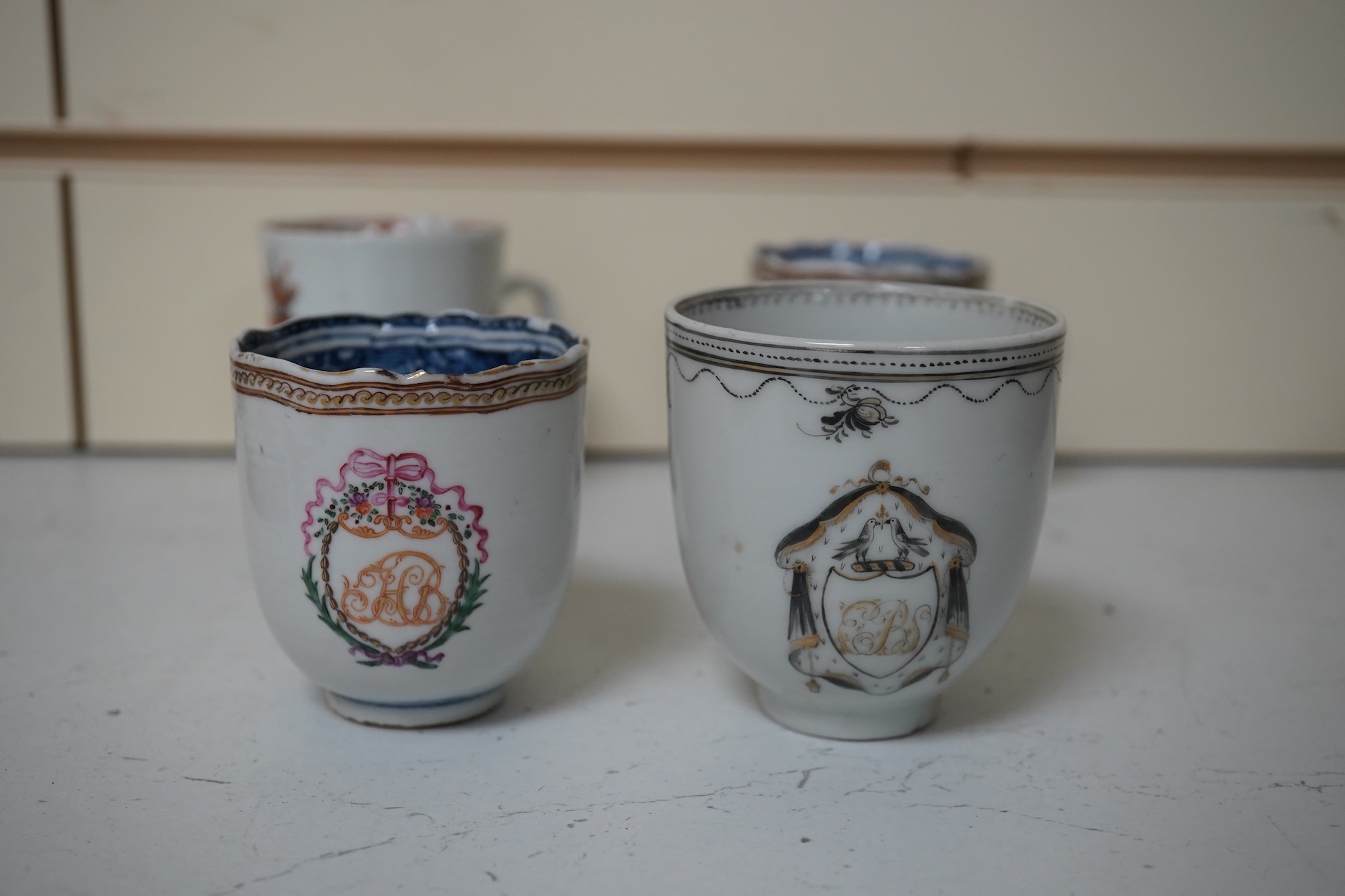 Six assorted 18th century Chinese export coffee cups with armorial decoration, and a similar European subject cup and saucer. Condition - damaged/restored